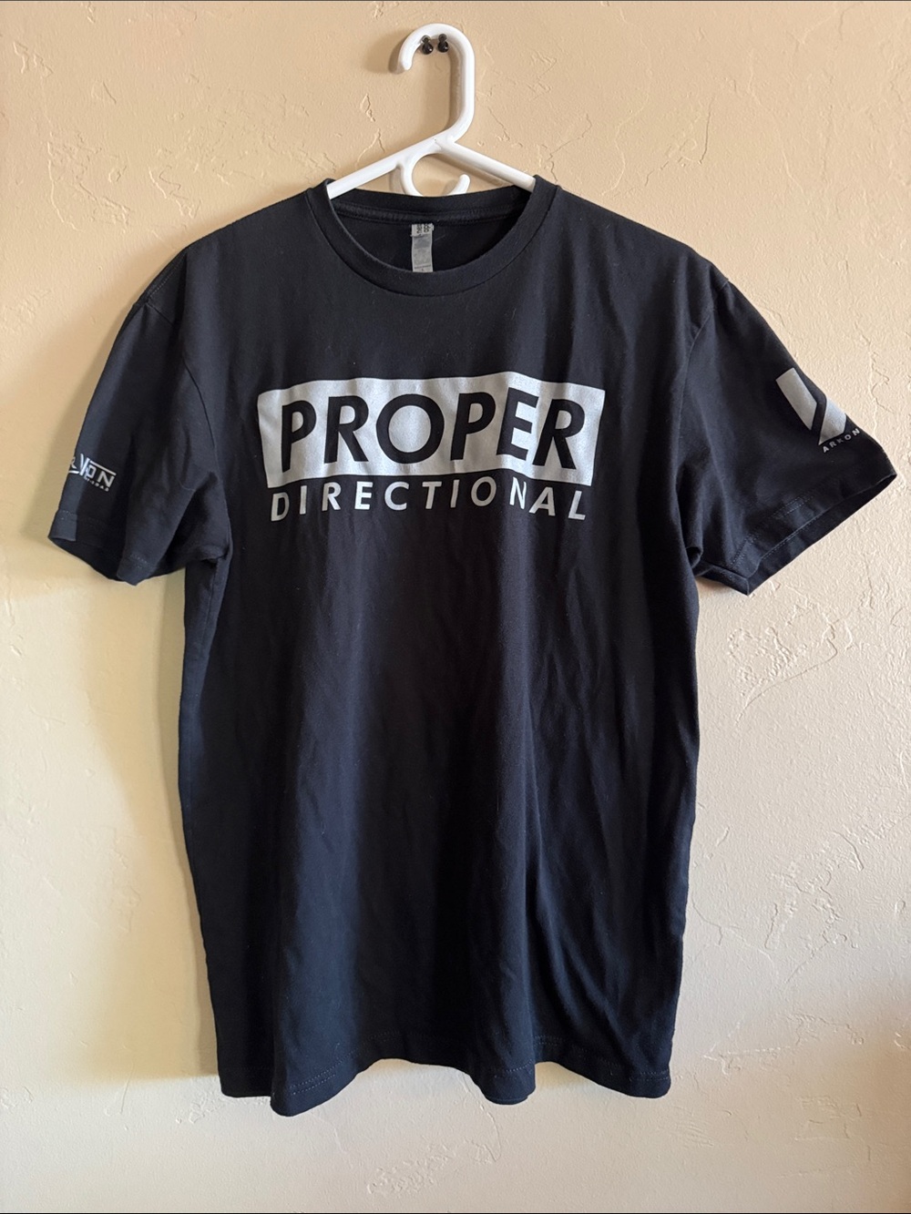Next Level Apparel Black Tee with White "PROPER DIRECTIONAL" Graphic